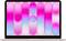 A laptop displaying a colorful abstract design with pink and blue gradient shapes on the screen.