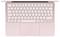 A rose gold laptop keyboard is shown from above, featuring a trackpad below and German QWERTZ layout.
