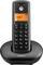 A black cordless phone with a digital screen displaying the word 'Contact'. It is placed in its charging base, showing standard dial pad.
