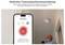 Man tests smoke detector using a smartphone. Screen displays 'Test Device' for simple test mode and mute function.