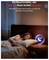 A woman sleeps in a bed. On a bedside table stands a smartphone with a glowing moon symbol. Text: 'A smoke alarm that cares about your sleep'.