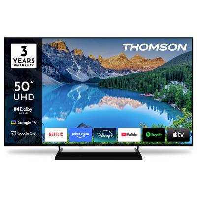 A Thomson 50" UHD TV display showing a scenic mountain lake. Features include Dolby Audio, Google TV, and apps like Netflix and YouTube.