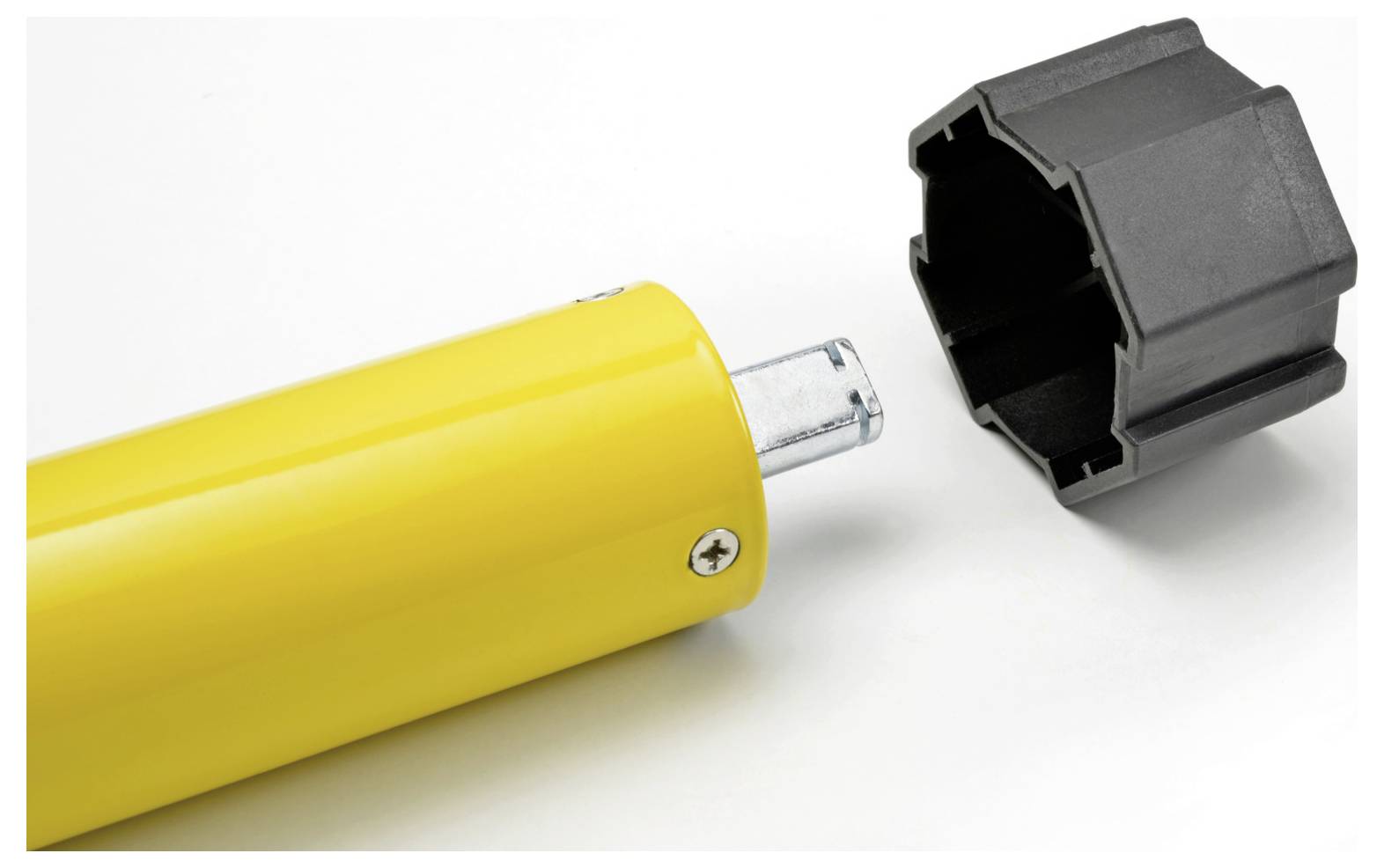 A close-up image of a yellow cylindrical object with a metal rod protruding, next to a detached black cap or connector.