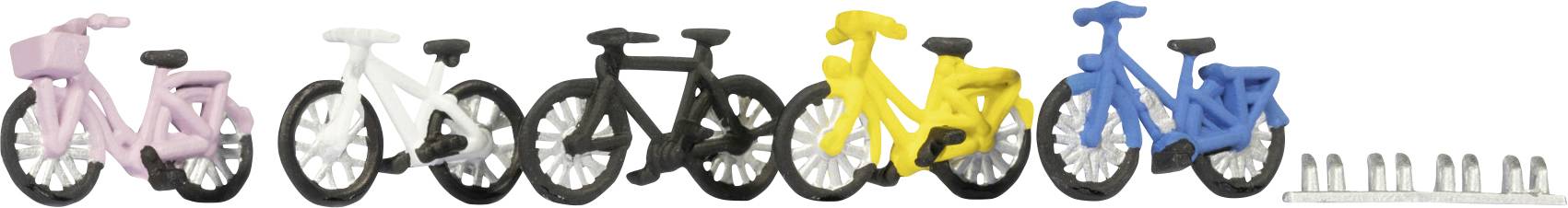 Colorful plastic bicycle models in a row: pink, white, black, yellow, and blue, followed by small metallic cylinders on the right.