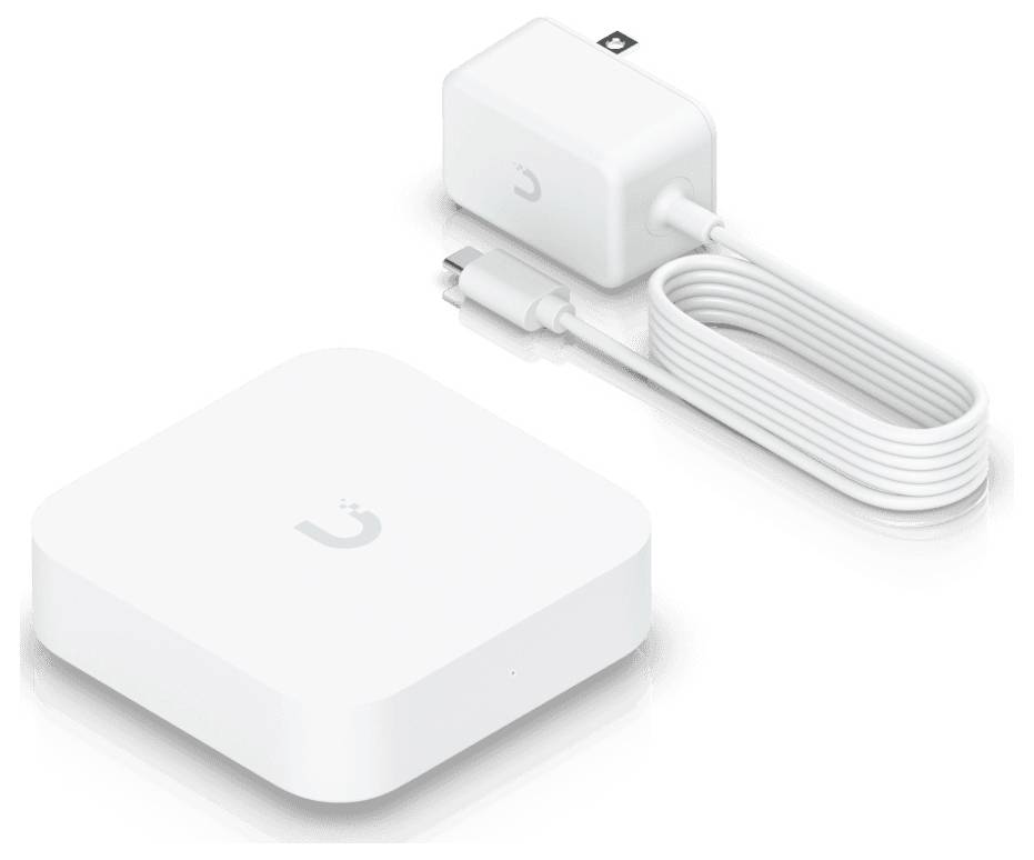 'White square-shaped device with a small logo, paired with a charger and USB cable, used for connecting smart home devices.'