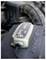 A battery charger device connected to a car engine, indicating battery maintenance or charging in progress.