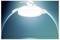 A ceiling fan with an integrated light fixture is illuminated, casting a bright white light. The background is a gradient of blue hues.
