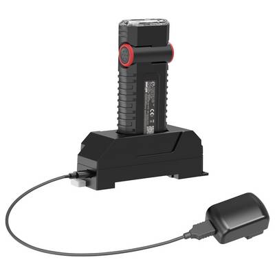 Black battery pack charging in a dock with a cable connected to an external power adapter.