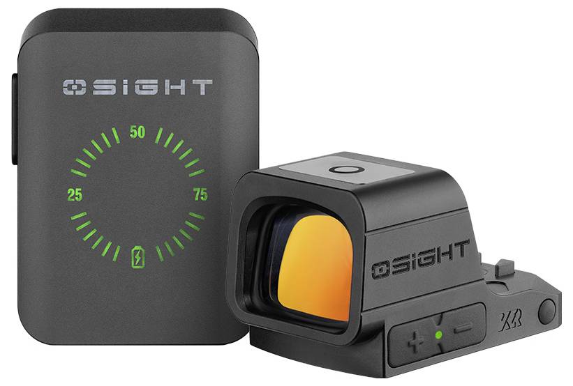 'A black electronic device with a screen displaying a green semi-circle and a black sight attachment with an orange-tinted lens.'