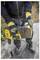 A person wearing gloves uses a power tool in an outdoor setting. The tool is a yellow and black drill with a focus on changing its battery.