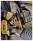 A person wearing protective gloves holds and examines a yellow 54V DEWALT power tool with a removable XR FLEXVOLT battery outdoors.