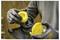 A person is wearing gloves while assembling or disassembling a yellow component of a garden tool or equipment, possibly a trimmer spool.