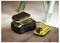 'Stanley battery charger and battery on a wooden surface; charging with a green indicator light, ladder in the background.'