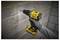 'A person using a yellow cordless power drill to make a hole in a brick wall, wearing a grey glove for protection.'