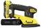 A yellow and black cordless electric sander with a detachable dust collection bag.