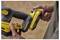 A person inserts a 'Stanley Fatmax V20' 2.0Ah battery into a tool. The tool is black and yellow with a textured grip.