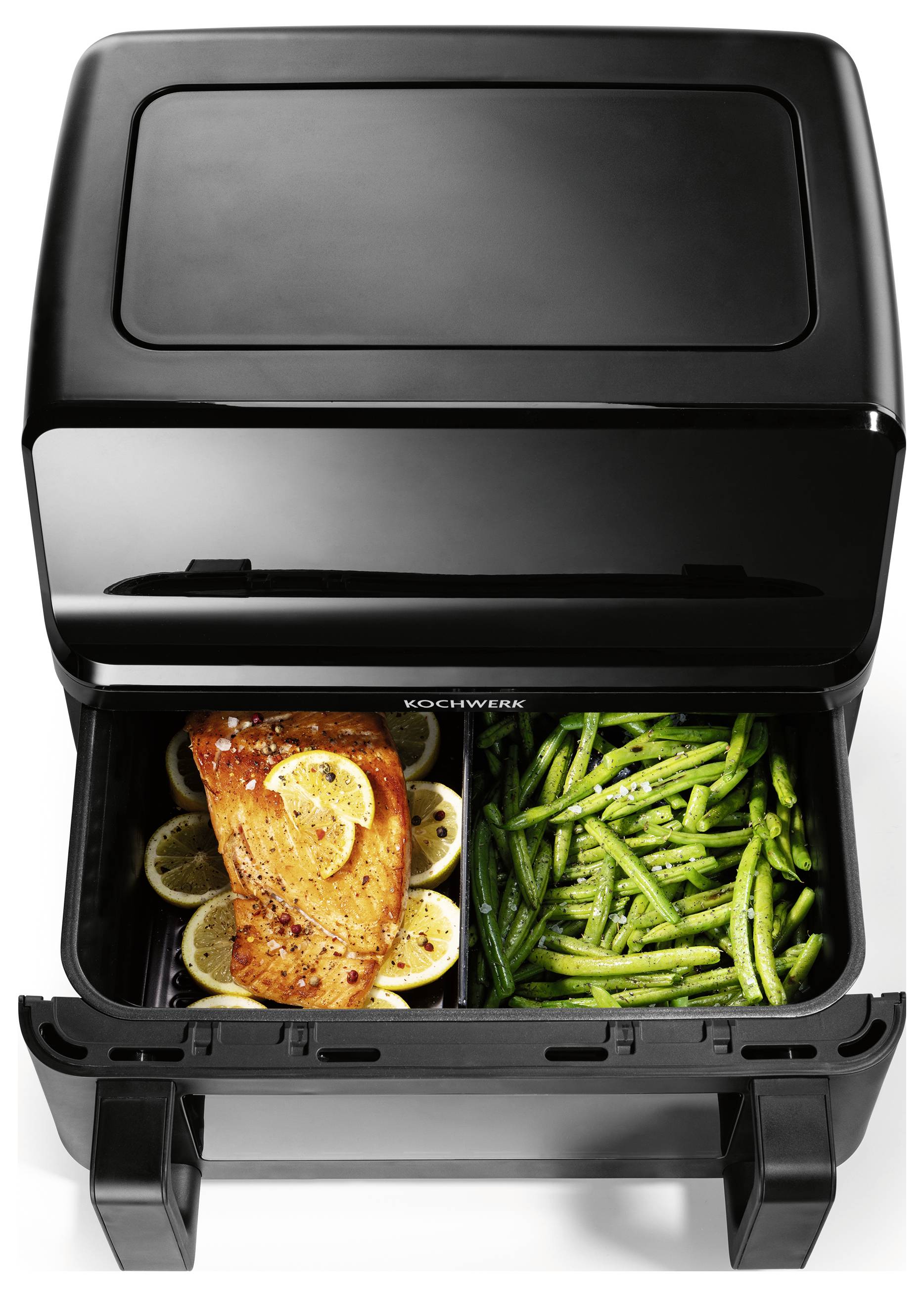 A dual compartment air fryer cooking salmon on lemon slices in one tray and green beans in the other.