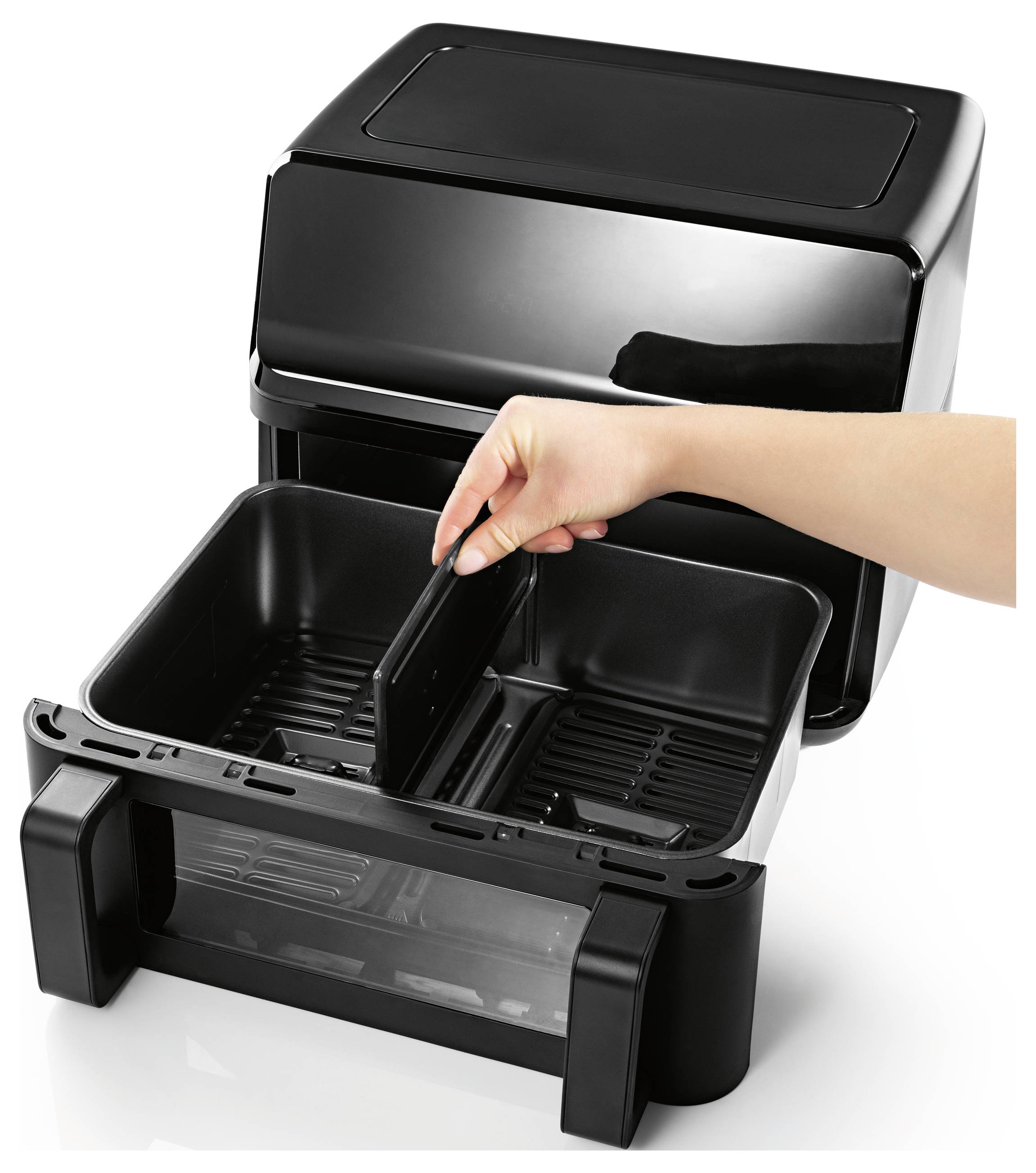 A hand is opening a black dual-basket air fryer, showcasing its spacious compartments designed for cooking separate food items simultaneously.