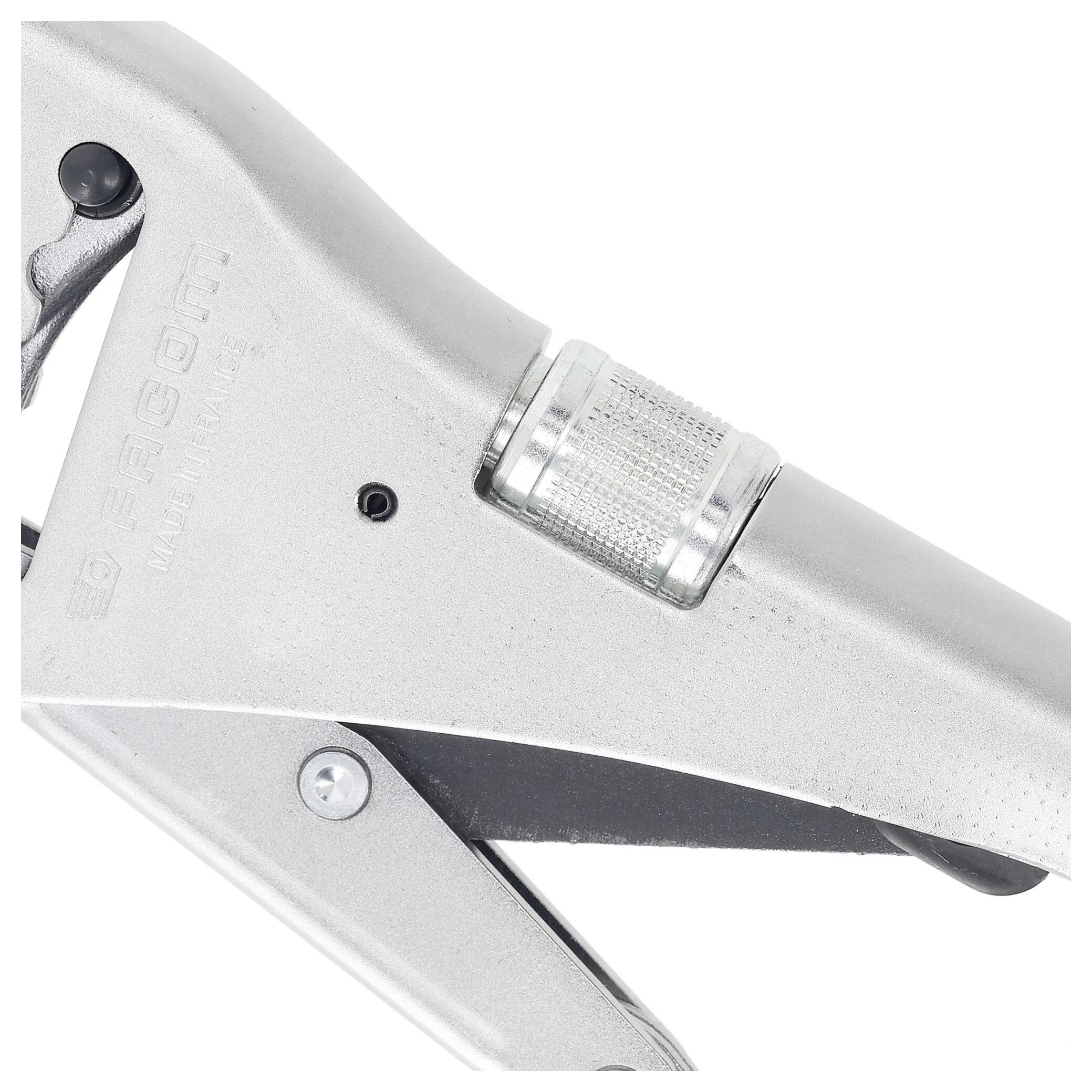 A close-up of a metallic hand tool, possibly a clamp or plier, with adjustable components and a textured grip for precise use.