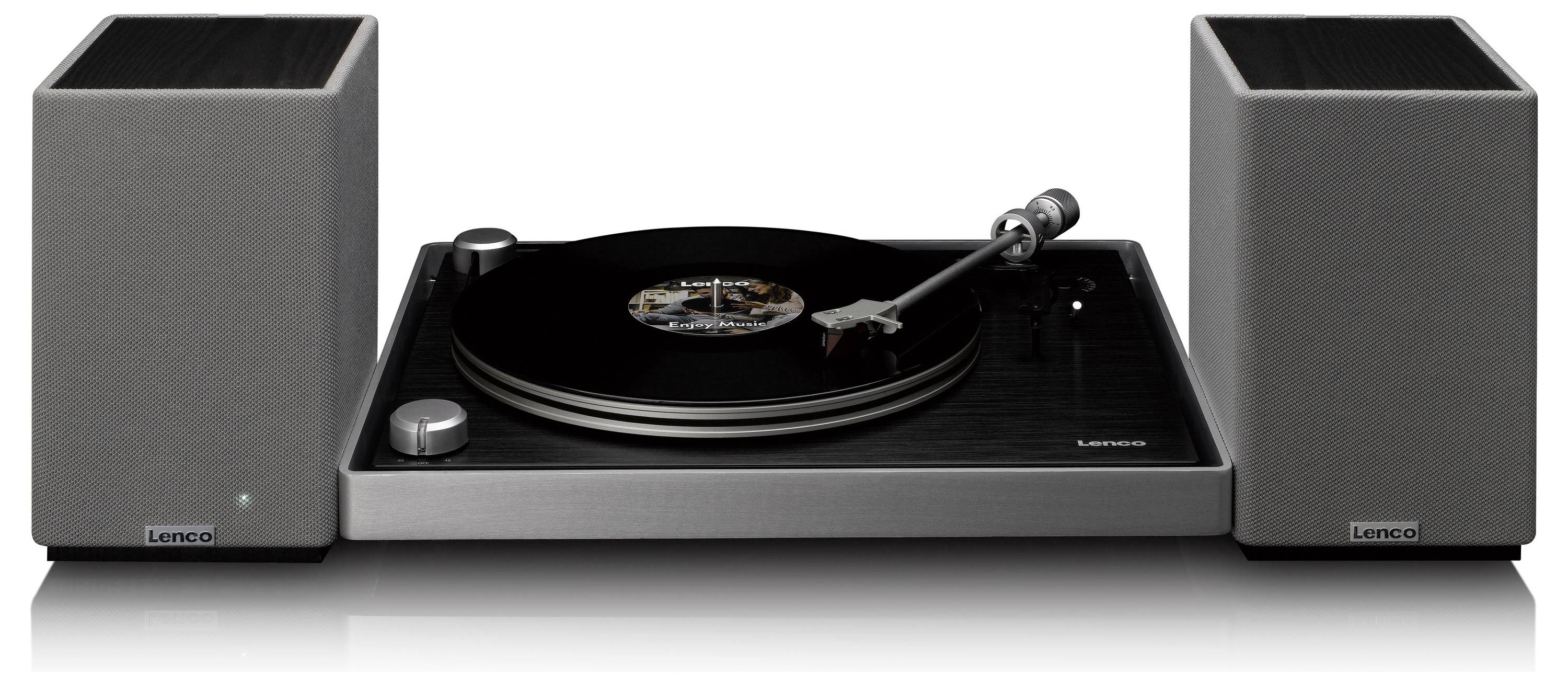 A modern record player with a vinyl record playing, flanked by two grey speakers.