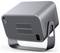 A sleek, metallic, cube-shaped electronic device with vented sides, a power button, and mounted on a curved metal stand.