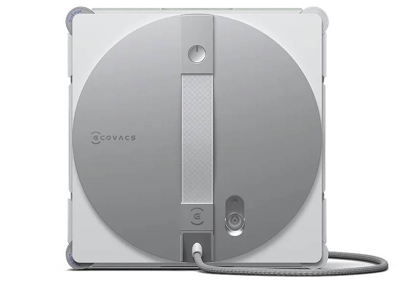 A square robotic cleaning device by ECOVACS, featuring a gray circular design on the front and a connected power cable at the bottom.