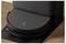 'A robotic vacuum docked at its charging station on a wooden floor.'