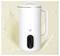 A white, modern electric milk frother with a digital display and handle, set against a splash background, indicating motion or usage.
