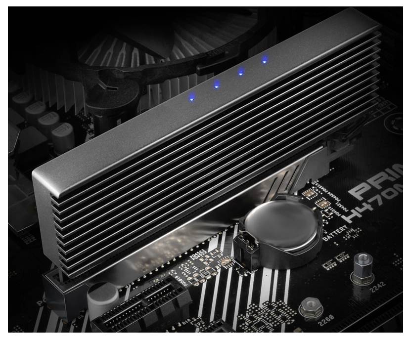 Close-up of an NVMe SSD heatsink on a motherboard, with blue indicator lights and visible battery and circuitry.<br>