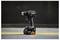 Black DeWalt cordless drill standing upright on its battery pack against a dark industrial background with a yellow floor line.