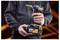 Person holding a DEWALT cordless right-angle drill with a step bit and matching battery pack.