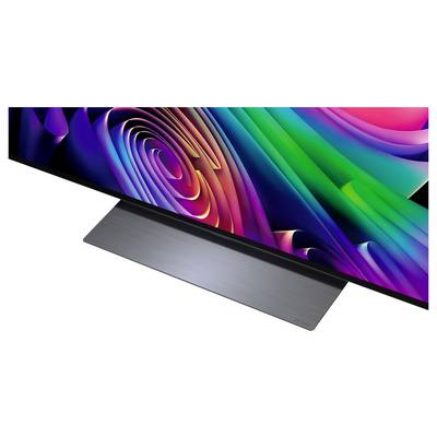 A sleek flat-screen TV with a colorful abstract swirl display on a brushed metal stand.