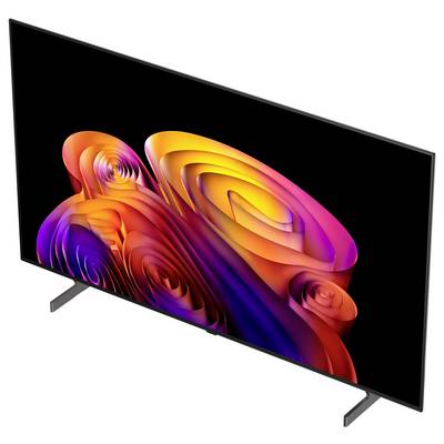 Flat-screen TV with abstract colorful swirl wallpaper on a black display, shown at an angle on two stand legs.<br>