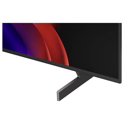 Close-up of a flat-screen monitor with a black bezel and stand, showing a dark abstract red and blue wave on the display.<br>
