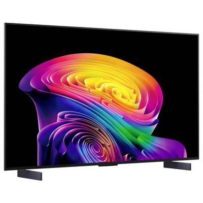 A flat-screen TV displaying a bright rainbow swirl on a black background, shown on a stand.