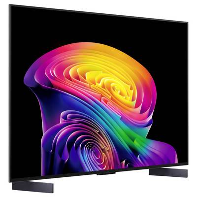 Flat-screen TV displaying a colorful abstract spiral design on a black screen, shown in a three-quarter view on a stand.