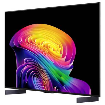 Flat-screen TV displaying a vivid abstract rainbow swirl on a black background, shown at an angle on two dark feet.