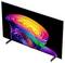 A sleek flat-screen TV on a white background displays a vivid abstract rainbow swirl on a black screen, shown at an angled perspective.