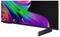 A widescreen TV or monitor displaying a colorful abstract ribbon pattern on a black screen, shown on a stand against a white background.
