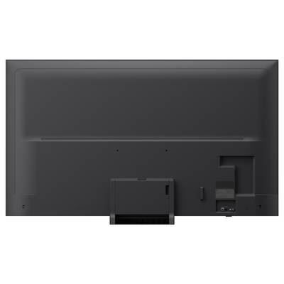 Back view of a flat-screen TV with central stand, showing ports and cable connections near the lower right.