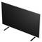 Flat-screen television with blank black screen on two stand legs, shown at an angle on a white background.