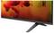 A flat-screen LG C1 OLED TV on a stand, shown at an angle with a vivid red-orange abstract image on the screen.<br>