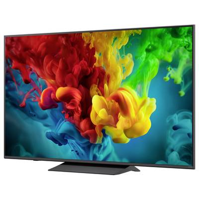 Flat-screen TV displaying a vivid abstract splash of red, yellow, green, and blue paint on a dark background.