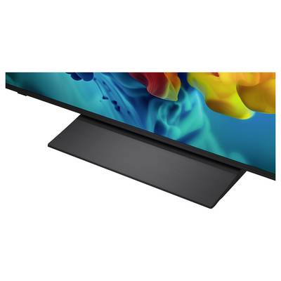 Close-up of a flat-screen TV with a dark triangular stand on a white background.