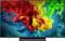 Flat-screen TV displaying a vivid abstract image of swirling red, yellow, green, and blue ink-like clouds on a dark background.