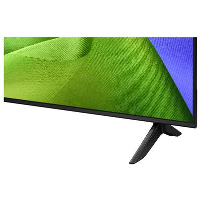 Close-up of a flat-screen TV or monitor showing a green and blue abstract display on a black stand.