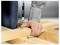 Close-up of a person driving a screw into a wooden beam with a power drill during carpentry assembly.
