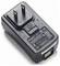 Black wall power adapter with two flat prongs and USB output port, shown on a white background.