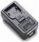 Black battery charger with slide-in cradle for a removable camera battery, shown on a white background.
