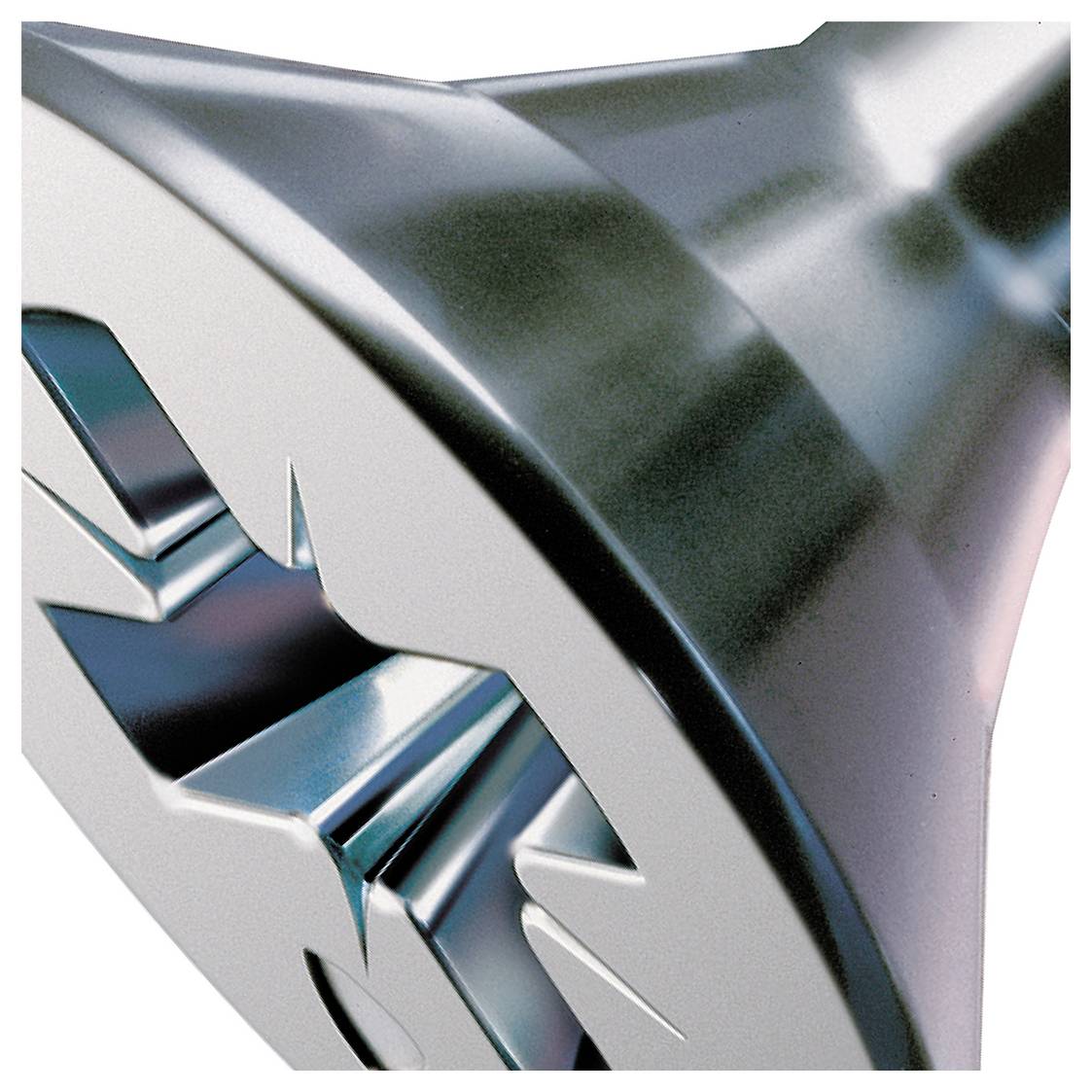 Close-up of a metallic, futuristic abstract sculpture with sharp faceted surfaces and blue reflections on a white background.